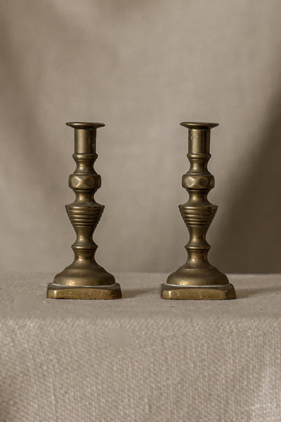 A Pair of Antique Sculptural Brass Candlesticks